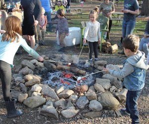 Gather up the family for s'more fun things to do this weekend with kids in CT. Family Around the Campfire photo by Zoe Brown, Earthplace.