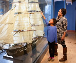 Image of mother and child with model ship - Christmas Vacation in Boston