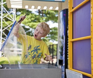 Image of child playing with bubbles at the Ecotarium.