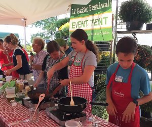 Local children and teens compete in Junior Garlic Iron Chef to create a master garlic-flavored pasta sauce - in front of a live audience - in only half an hour at the Garlic Festival at the Garden Of Eve. Photo courtesy of the farm
