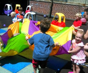 Kids play with a parachute at Elliot's gymnastics classes for kids