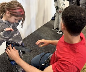 HAPIK climbing gym in Brooklyn: Girl gets fitted with safety harness