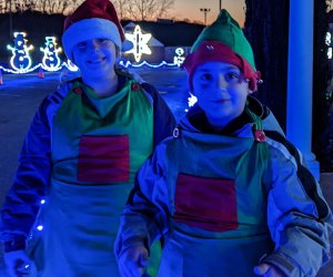 Warm smiles from a pair of friendly elves at the Hebron Lions drive-thru holiday light show at Hebron Fairgrounds. Photo courtesy of Hebron Lions Lights in Motion, Facebook