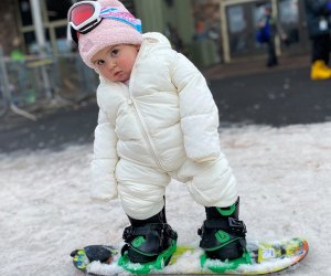 Little girl toddler snowboarding at Hunter Mountain in New York state