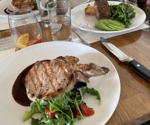 Pork chop on a plate at Three Peaks Lodge at Collective Governors Island