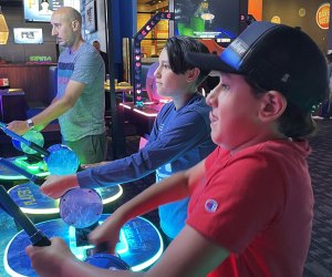 playing arcade games at Dave & Busters Long Island Arcades