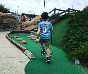 Mini-Golf Courses on Long Island child playing mini golf at County Fair Park