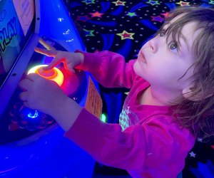 Toddlers love the bright lights of the arcade at Planet Play in Bellmore. Photo by Gina Massaro