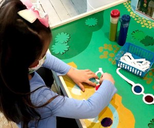 Girl playing with arts and crafts at the Long Island Explorium What's open Now Long Island