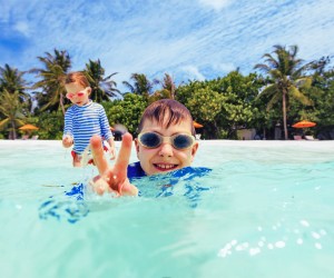 A  shallow, crystal-clear Maldives lagoon is the perfect place for kids to swim. 