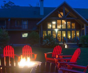 a campfire in front of a lodge