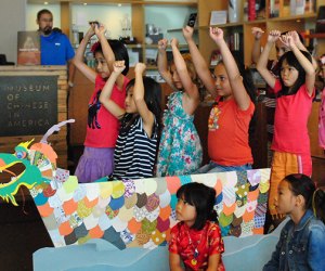 Kids get ready for Dragon Boat Festival by making their own craft.