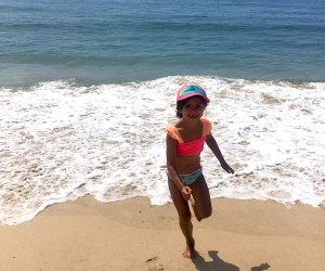 Girl playing in the surf at Montauk's Kirk Beach Park: Best Cute Town on Long Island