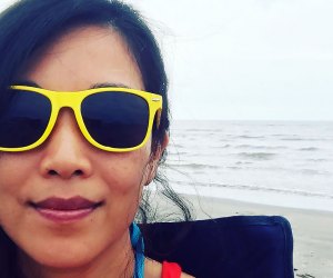 woman in bright yellow sunglasses on the beach