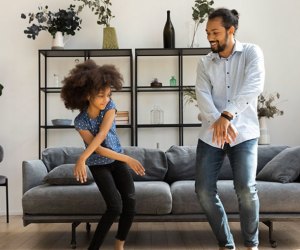 Father and daughter dance in their living room: Holidays & Activities for June 2025 National Dance Day