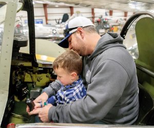 Image of father and son in a plane cockpit - Fall Bucket List for Kids