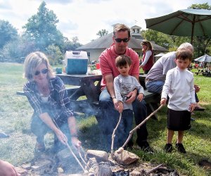 Families cook cornbread over the fire at Cider Saturday. Photo courtesy of New Canaan Nature Center