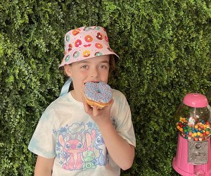 Kid eating a donut wearing a donut hat - Photo by Kelly Patino for Mommy Poppins National Donut Day