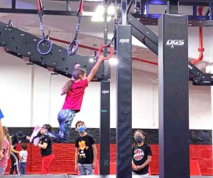 girl swinging on rings at New York Ninja Academy NYC Birthdays