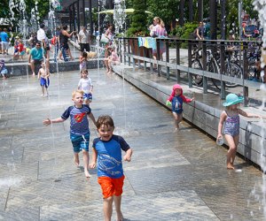 Photo of children splashing in a Rose Kennedy Greenway sprinkler park. 