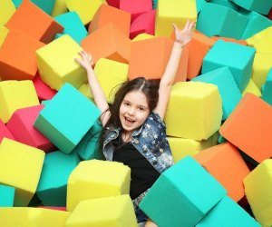 Girl in a foam pit at Kids 'N Shape, a trampoline park in New York City