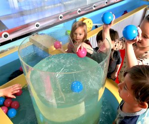 Twinkle Playspace's water table let’s kids toss objects into its whirlpool.