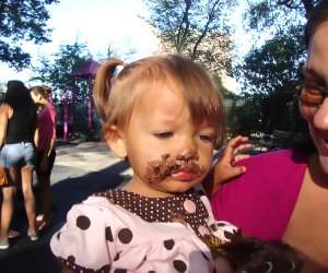 Best things to do in NYC with babies: First birthday party baby with messy, cake-covered face