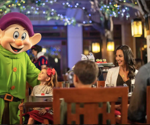 Celebrate your child’s birthday with Snow White, Dopey, and Grumpy at Story Book Dining at Artist Point. Photo courtesy of Disney