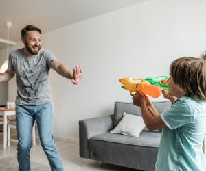 Dad has water gun fight in the house with kids as an example of permissive parenting.