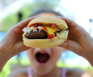 girl eating a hamburger at squareburger