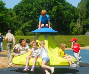 Photo of kids on a merry-go-round at Pease Place playground in CT.