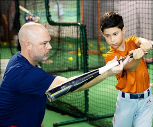 Boy practicing his swing. Photo courtesy of HIT Indoor Baseball and Softball Camps 