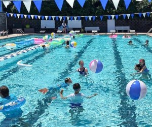 Photo of kids playing games in a large swimming pool.