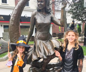 Photo of girls in witch costume by Salem's Bewitched statue