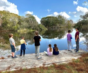 Kids fishing in a lake at EcoCamp. Photo courtesy of the Armand Bayou Nature Center 