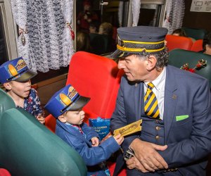 Photo of a conductor and passengers from Polar Express Train Rides.