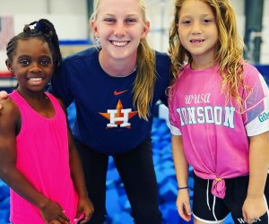 Two girls enjoying a fun gymnastics summer camp in Houston. Photo courtesy of the Houston Gymnastics Academy