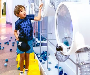 ​child playing with the Pom Pom Poll at the National Children's Museum.