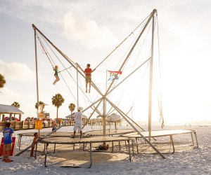 kids doing a bungee trampoline jump on the beach ni clearwater