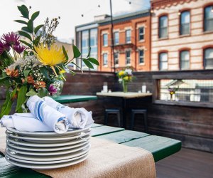 Table with plates on the rooftop patio at Porta