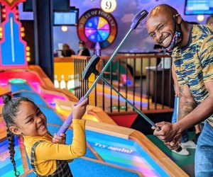 Photo of family playing mini golf - Best Fun Restaurants for Kids' Birthdays in Boston
