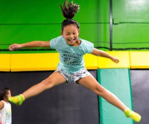 Girl doing a mid-air split at Rockin' Jump Trampoline Park
