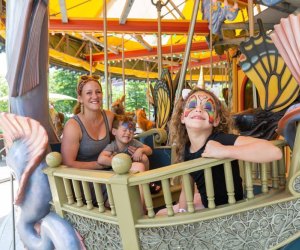 Photo of family on carousel on Boston Greenway.