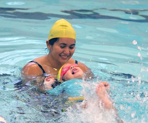 swim instructor in the pool with a toddler swim class