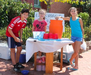 Kids selling lemonade at a lemonade stand