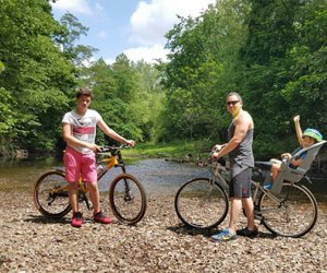 Family poses for a picture along a bike path