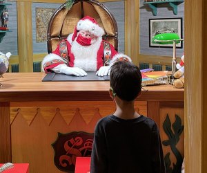 Santa invites young visitors to step into his office and share their wishlists at Macy's Santaland in 2021. Photo by Diana Kim