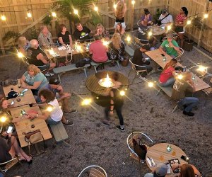 outdoor dining with in a restaurant backyard with string lights strewn above