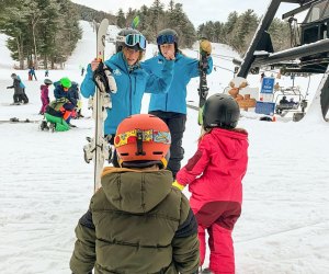 Photo of family near chair lift at a New England ski resort.