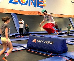 kids of all ages jump and try tricks at sky zone trampoline park